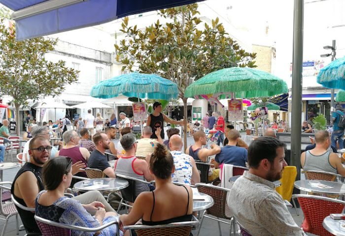 Central Bar Books, a popular gay bar in Sitges, Spain. Outdoor seating area filled with people enjoying drinks and conversation.