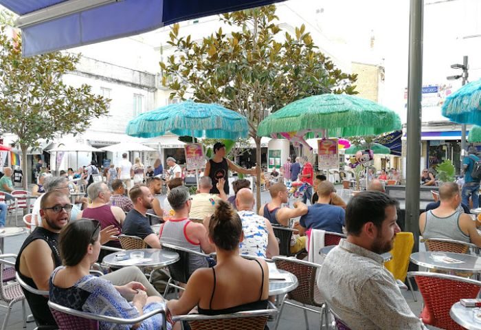 Central Bar Books, a popular gay bar in Sitges, Spain. Outdoor seating area filled with people enjoying drinks and conversation.