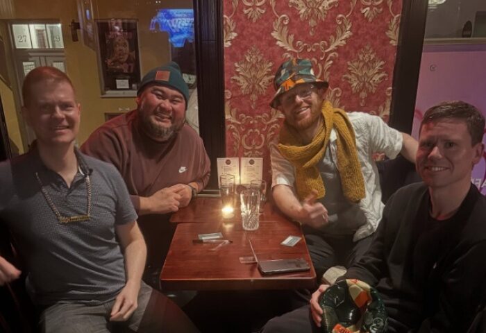 Four gay men at Centre Stage CPH bar, Copenhagen. Travel advice: enjoy the vibrant gay scene, drinks, and good company in Denmark.