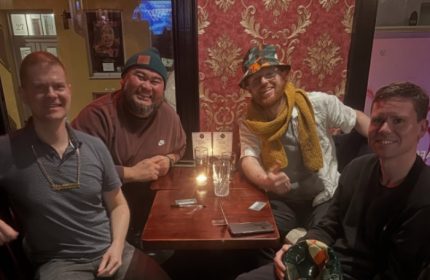 Four gay men at Centre Stage CPH bar, Copenhagen. Travel advice: enjoy the vibrant gay scene, drinks, and good company in Denmark.