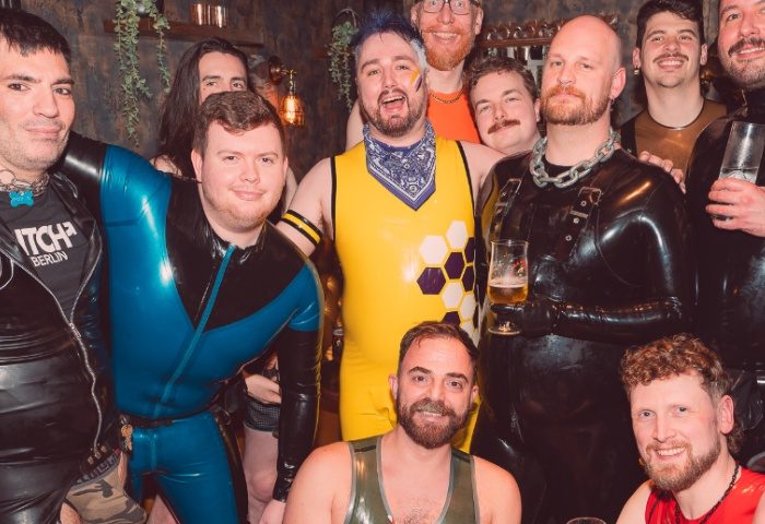 Gay men at Centre Stage Manchester, a gay travel destination. Group in fetish wear: latex, leather, harnesses, and dog collars. Nightlife.
