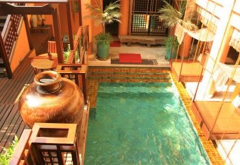 Chakran Gay Sauna Bangkok swimming pool. Cheap gay sauna with a pool, tropical plants, and swinging beds for a relaxing gay travel experience.