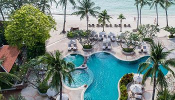 Chaweng Regent Beach Resort, Koh Samui. Aerial view of pool, beach, palm trees. Luxury beachfront hotel for gay travelers.