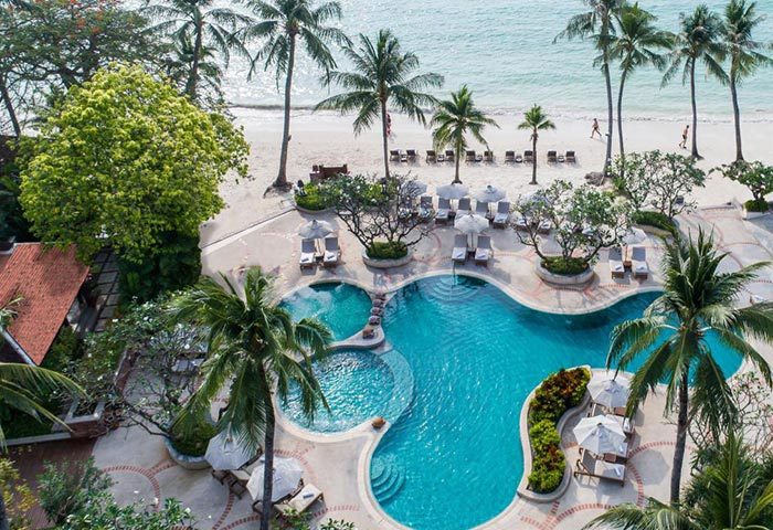 Chaweng Regent Beach Resort, Koh Samui. Aerial view of pool, beach, palm trees. Luxury beachfront hotel for gay travelers.