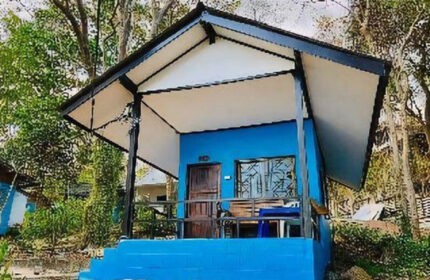 Pudsa Bungalow, Koh Samet. Cheap beachfront gay hotel with blue bungalow, porch, and trees. Gay travel advice in Thailand.