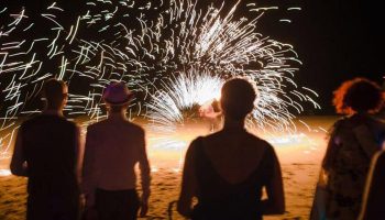 Beachfront fire show at Phi Phi Relax Beach Resort. Guests enjoy the spectacle at this cheap gay-friendly hotel. Nightlife in Thailand.