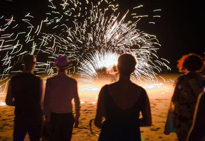Beachfront fire show at Phi Phi Relax Beach Resort. Guests enjoy the spectacle at this cheap gay-friendly hotel. Nightlife in Thailand.