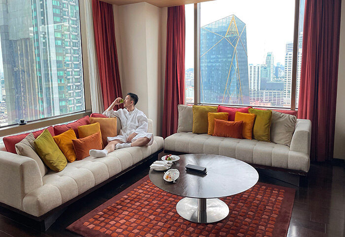 Gay traveler relaxing at VIE Hotel Bangkok, a cheap gay hotel with city view. Luxury suite at MGallery hotel in Bangkok.
