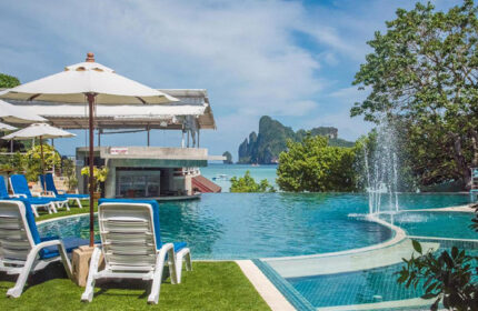 PP Charlie Beach Resort's rooftop pool in Koh Phi Phi. Beachfront view, lounge chairs, and bar. A cheap gay hotel option this year.