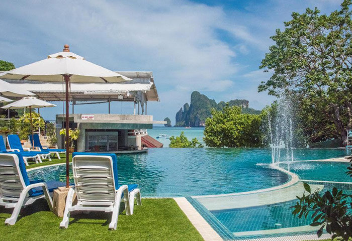 PP Charlie Beach Resort's rooftop pool in Koh Phi Phi. Beachfront view, lounge chairs, and bar. A cheap gay hotel option this year.