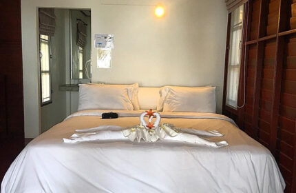 Tubtim Resort, Koh Samet. Room interior at this cheap gay hotel near gay nightlife. Bed with swan towel art and white linens.