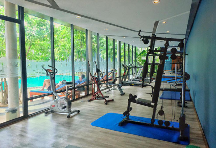 The Tama Hotel's gym near Railay Beach, Krabi. Cheap gay hotel with treadmills, exercise bikes, and weight machines. Pool view.
