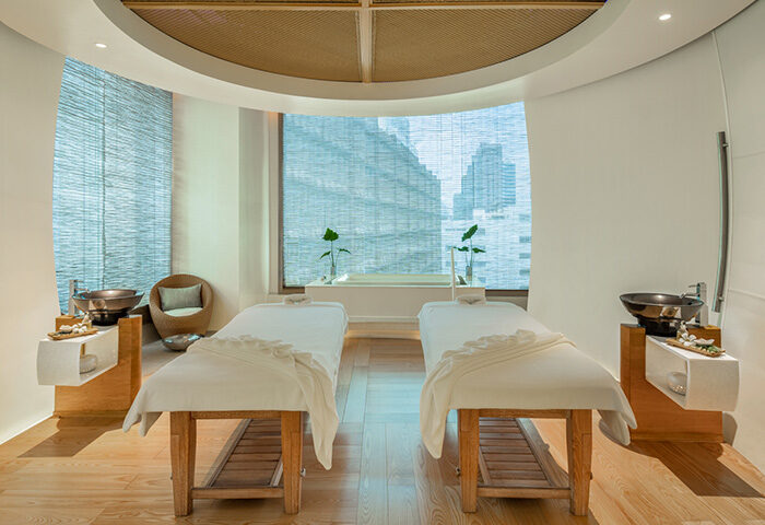Le Méridien Bangkok spa. Gay hotel spa package with two massage beds, sinks, and a city view. A cheap spa day for gay men's travel.