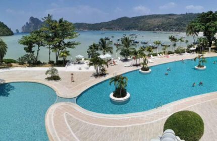 Phi Phi Island Cabana Hotel pool view. Gay travel in Ton Sai, Thailand. Cheap hotel with ocean view and island landscape. Palm trees.