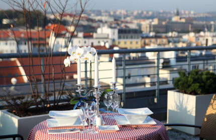 Ibis Praha Old Town Hotel's rooftop bar: A romantic table is set with a view of Prague. Perfect for gay travelers in Prague.