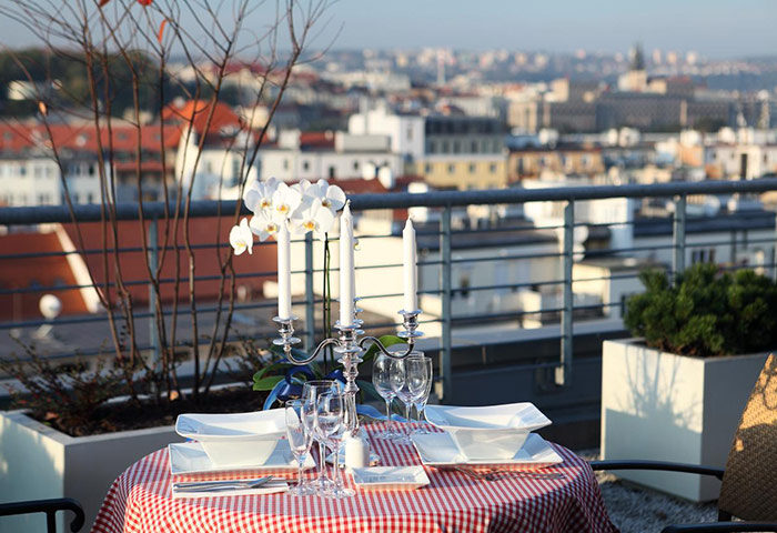 Ibis Praha Old Town Hotel's rooftop bar: A romantic table is set with a view of Prague. Perfect for gay travelers in Prague.