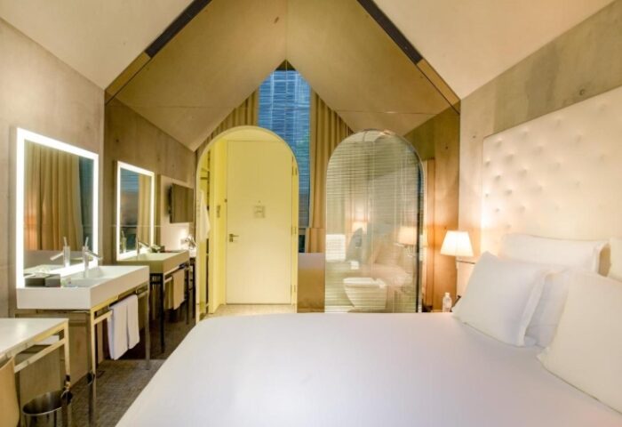 M Social Singapore hotel room. Stylish design, bathroom view. Gay-friendly hotels in Singapore offer unique experiences for LGBTQ+ travelers.