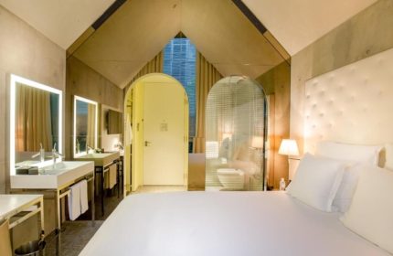 M Social Singapore hotel room. Stylish design, bathroom view. Gay-friendly hotels in Singapore offer unique experiences for LGBTQ+ travelers.