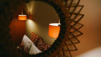 Rambutan Resort Siem Reap room detail. Mirror view of pillows and lamps. Cheap gay hotels in Siem Reap city center for gay travel.