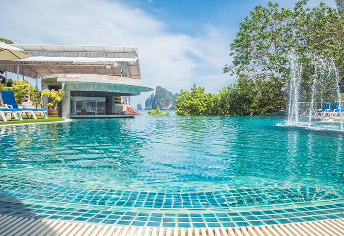 PP Princess Resort rooftop pool with Ton Sai beachfront view. Cheap gay hotels offer luxury. Fountain and bar enhance the experience.