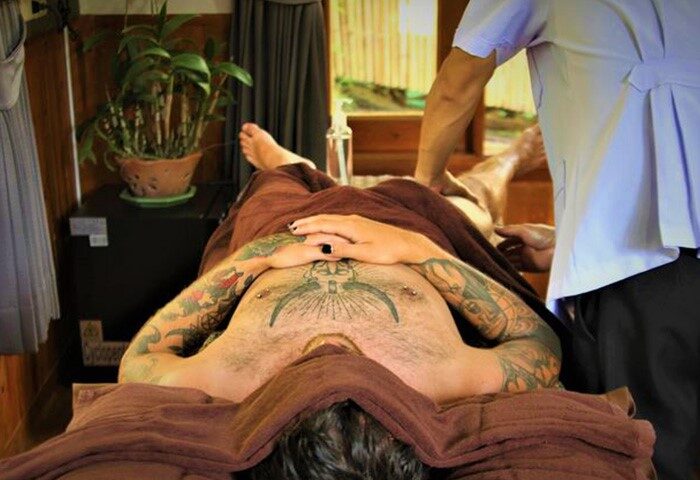 Gay man receiving massage at Alpha Gay Resort & Spa, a gay men-only hotel in Koh Samui. Cheap gay hotel with sauna. Spa treatment.