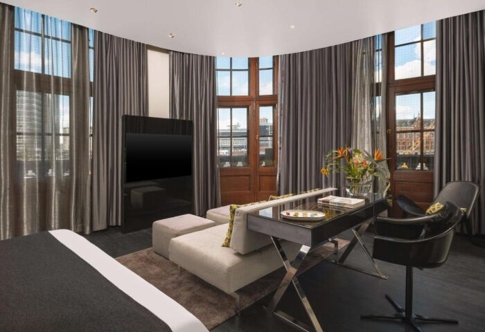 art'otel Amsterdam room. Cheap hotels near gay bars & saunas. Modern design, TV, desk, and seating area. Great for gay travelers.