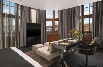 art'otel Amsterdam room. Cheap hotels near gay bars & saunas. Modern design, TV, desk, and seating area. Great for gay travelers.