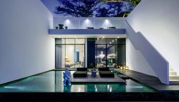 Library Hotel Koh Samui: Gay-friendly beachfront luxury. Poolside view of modern suite, loungers, and unique design. Perfect for gay travel.