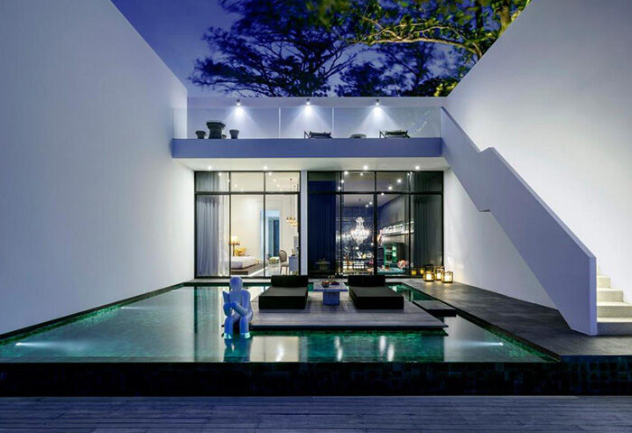 Library Hotel Koh Samui: Gay-friendly beachfront luxury. Poolside view of modern suite, loungers, and unique design. Perfect for gay travel.