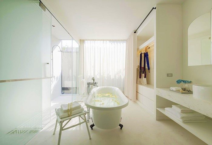 Luxury bathroom at Sala Lanna Chiang Mai, a gay-friendly hotel. Features a soaking tub, glass shower, and modern design. Great for gay travel.