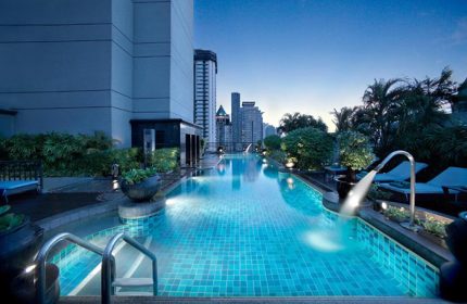 Banyan Tree Bangkok rooftop pool at dusk. A luxury gay hotel in Bangkok, Thailand. Perfect for gay men's travel and vacations.