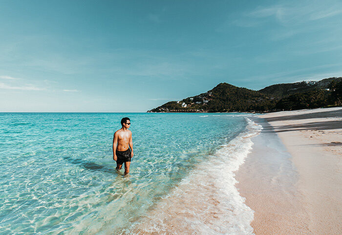 Gay traveler enjoying the beachfront pool at Vana Belle, a Luxury Collection Resort in Koh Samui, Thailand. Cheap luxury gay hotel.