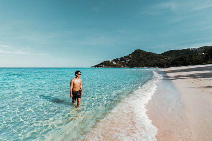 Gay traveler enjoying the beachfront pool at Vana Belle, a Luxury Collection Resort in Koh Samui, Thailand. Cheap luxury gay hotel.