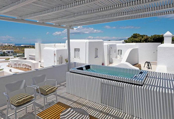 Andronikos Hotel Mykonos rooftop jacuzzi. Luxury gay hotel view with private bath. Relaxing travel destination for gay men.