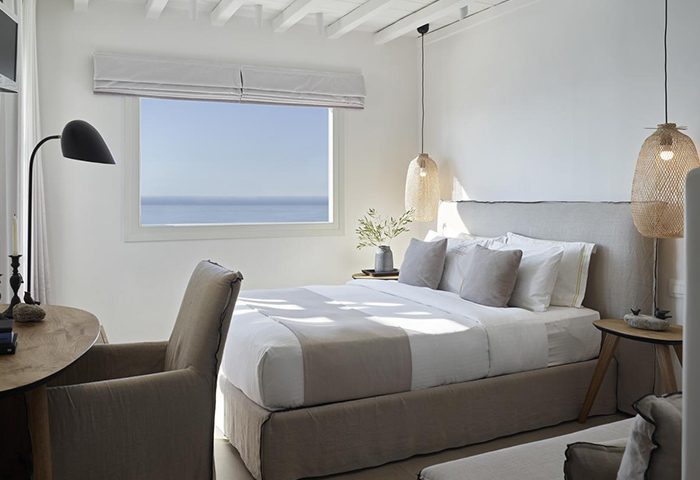 Vencia Boutique Hotel room, a cheap luxury gay hotel in Mykonos Town near gay bars. Bedroom interior with sea view. Ideal for gay travel.