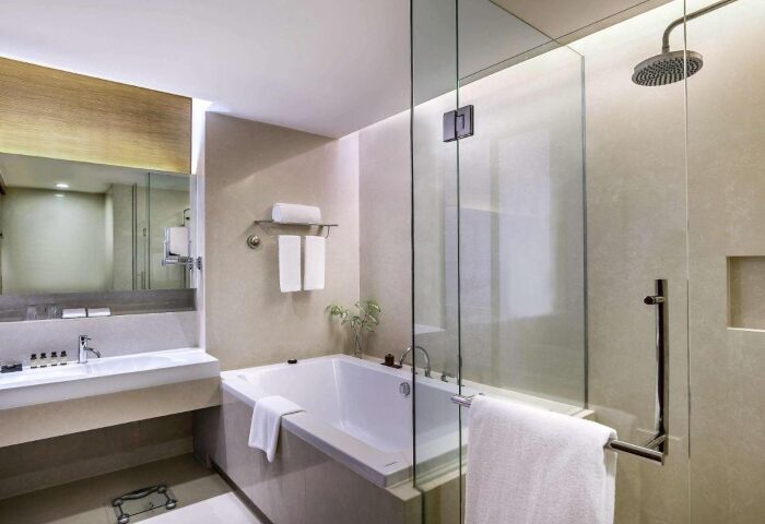 Bathroom at Pullman Bangkok King Power. Luxury hotel with bathtub and glass shower. Gay-friendly accommodation in Bangkok, Thailand.