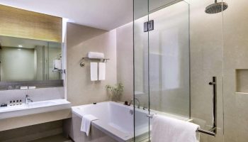 Bathroom at Pullman Bangkok King Power. Luxury hotel with bathtub and glass shower. Gay-friendly accommodation in Bangkok, Thailand.