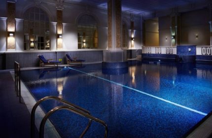 The Dilly Hotel's pool in London. A cheap-luxury gay hotel's pool, with blue tile, lounge chairs, and architectural columns. A Soho, London gem.