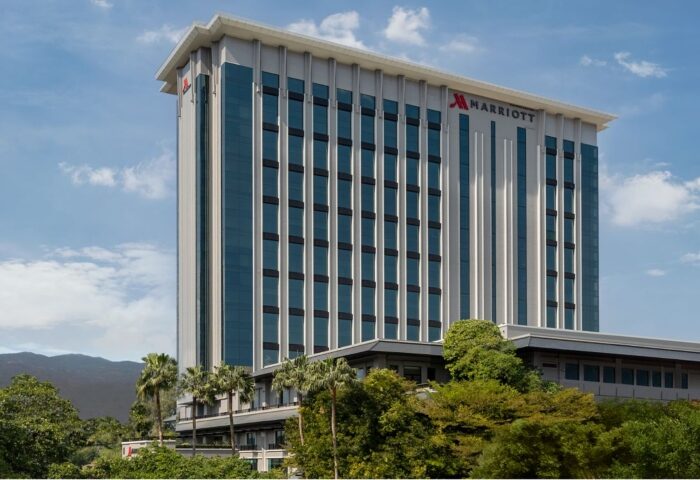 Chiang Mai Marriott Hotel exterior. Luxury gay-friendly hotel near gay bars in Chiang Mai, Thailand. Modern architecture with blue sky.