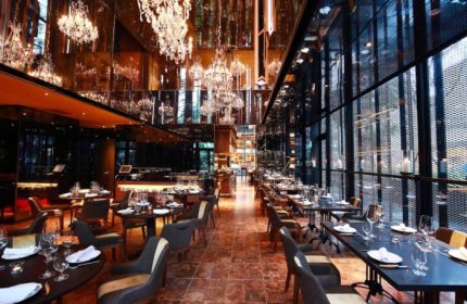 Hotel Proverbs Taipei's restaurant. A cheap luxury gay hotel near gay bars and saunas. The restaurant has chandeliers and tables set for dining.