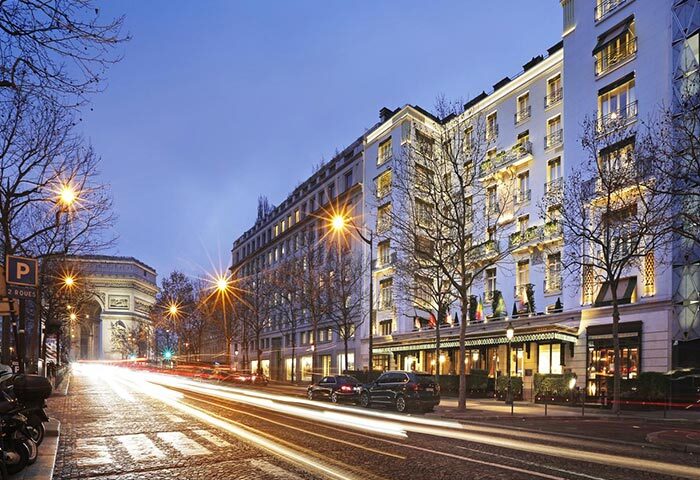 Hotel Napoleon, a cheap luxury hotel in Paris for gay couples. The Arc de Triomphe is visible in the background at dusk.