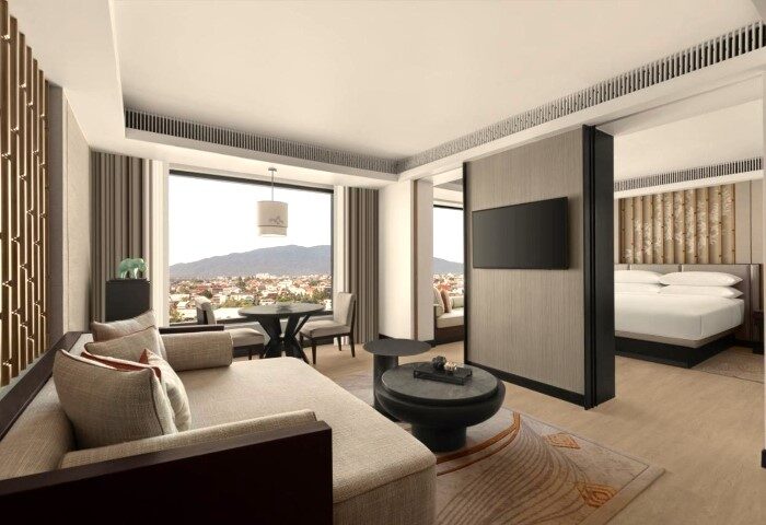 Chiang Mai Marriott Hotel suite interior. Luxury hotel near gay bars with city view. Modern design, bedroom, living room. Gay travel.