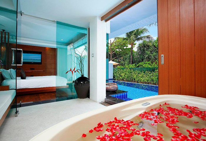La Flora Resort Patong pool villa. Honeymoon or gay hotel in Phuket. Cheap luxury with rose petals in tub, pool view.