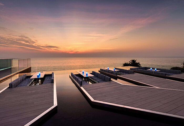 Veranda Resort Pattaya MGallery rooftop pool at sunset. Luxury gay hotel in Pattaya, Thailand. Relaxing travel destination.