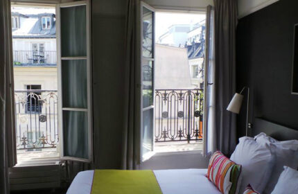 Duo Hotel, a cheap gay hotel in Paris' Marais district: Room view with open windows and balcony. A great gay travel idea for your trip.