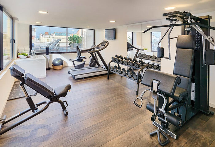 H10 Art Gallery Hotel gym in Barcelona's Eixample. Treadmill, weights, and multi-gym equipment. A cheap-price gay hotel with fitness.