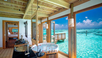 Gili Lankanfushi Maldives private pool villa bathroom with ocean view. Gay-friendly hotel for luxury travel. Maldives resort for gay men.