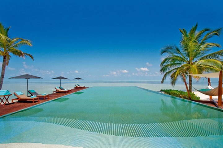 LUX* South Ari Atoll, Maldives: Infinity pool overlooking the ocean. Perfect gay holiday destination for a cheap tropical summer getaway.