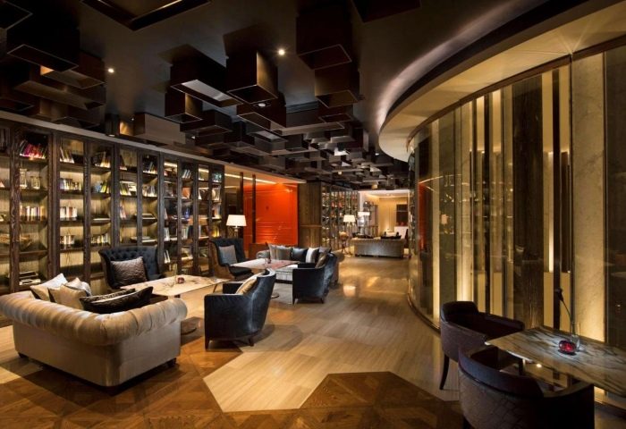 Lobby lounge at Hilton Sukhumvit Bangkok, a cheap upscale gay hotel in BKK. Interior view with bookshelves, sofas, and modern design elements.