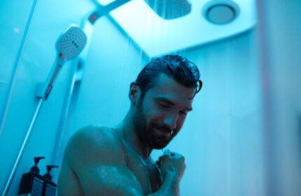 citizenM Copenhagen Radhuspladsen: Gay man showering in blue light. Upscale hotel in Vesterbro gayborhood. Cheap and stylish hotel.